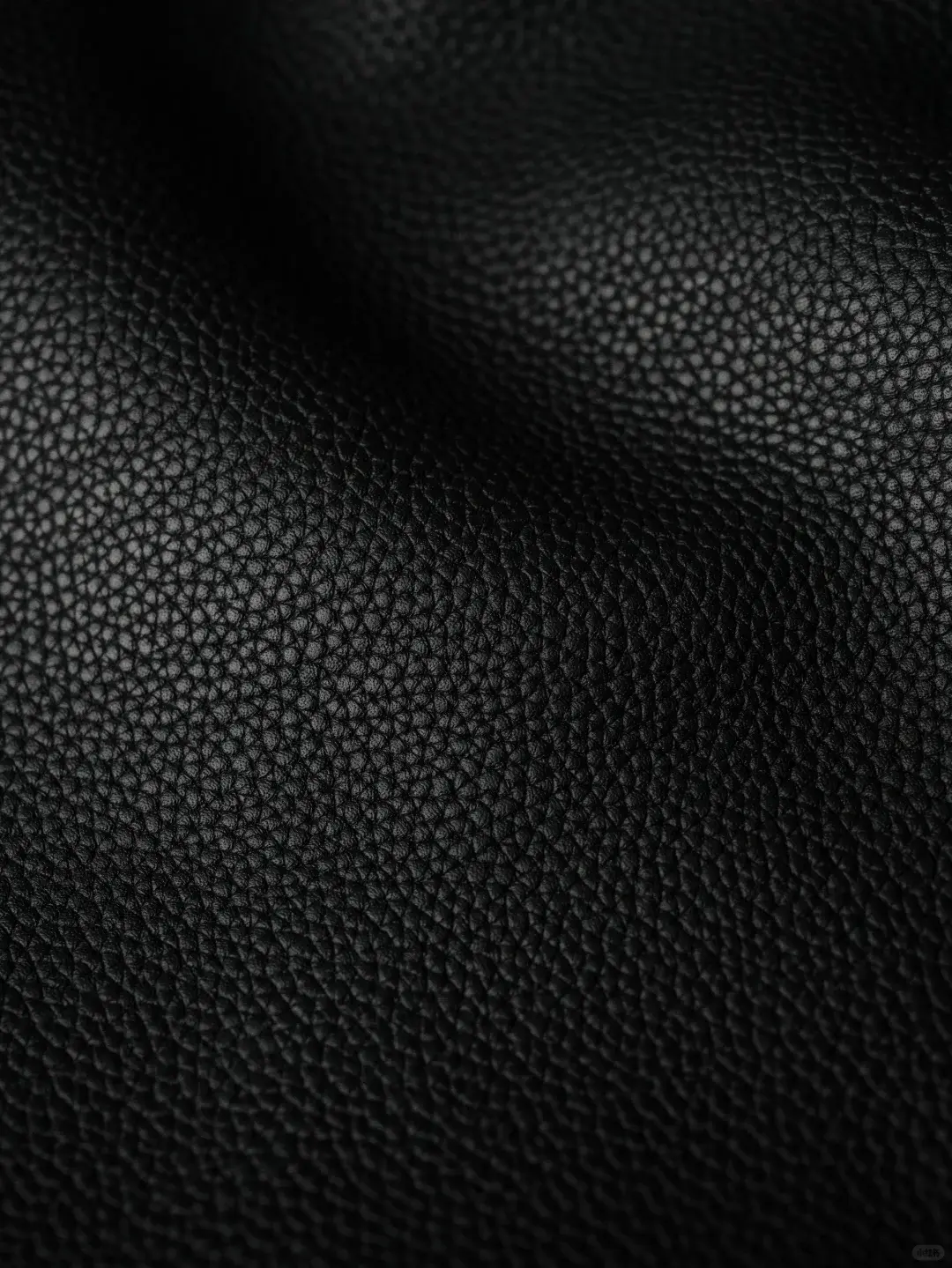 Black TOGO leather with a sculpted pebble grain